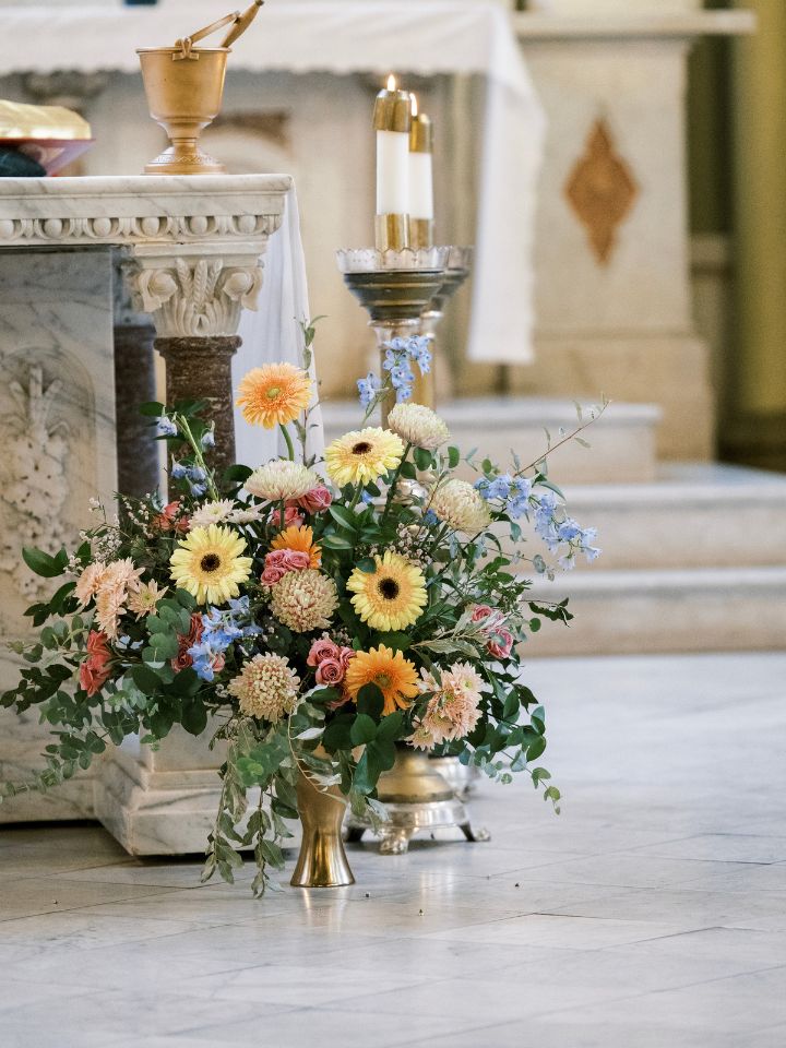 Large flower arrangement in church for wedding ceremony.