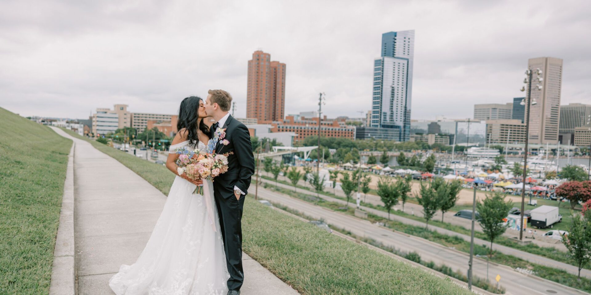 Bride and groom kiss on Federal Hill in Baltimore, Maryland.