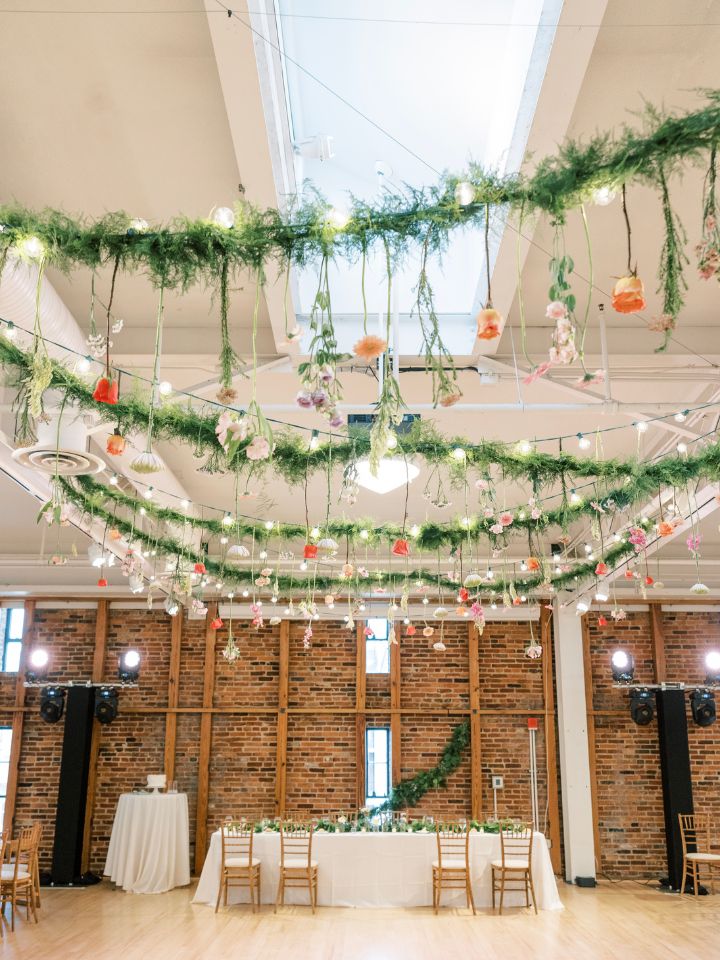 View of American Visionary Art Museum wedding reception space with suspended greenery from ceiling.