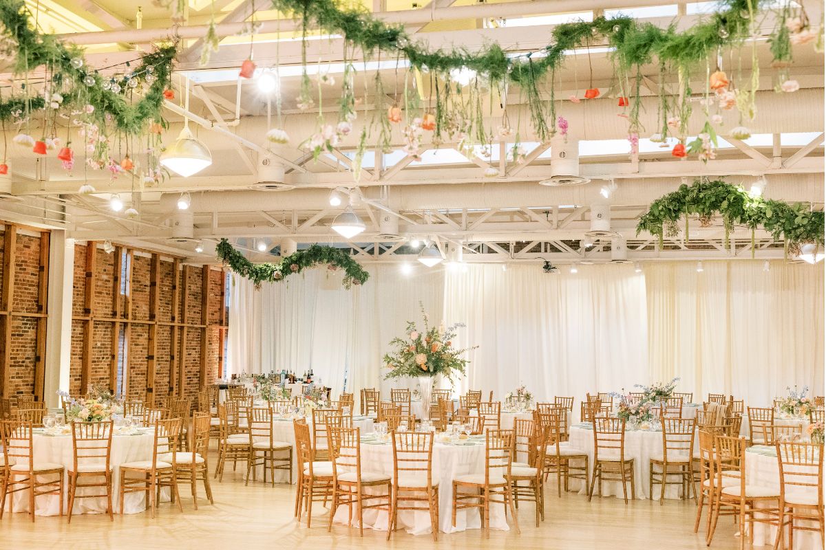 Reception space at the American Visionary Art Museum with suspended greenery and floral installations.