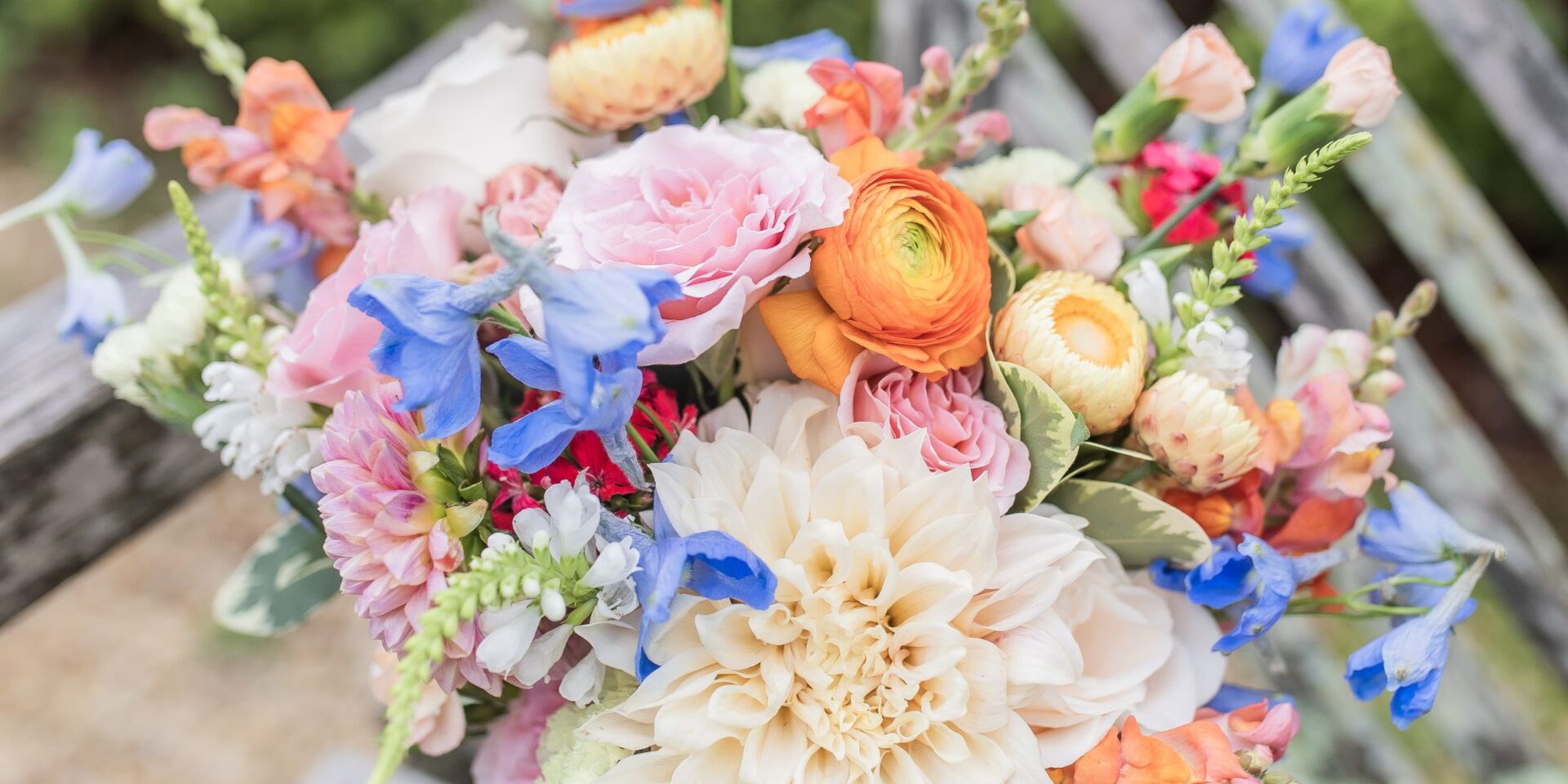 Closeup of bridal bouquet in colorful summer pastel flowers.