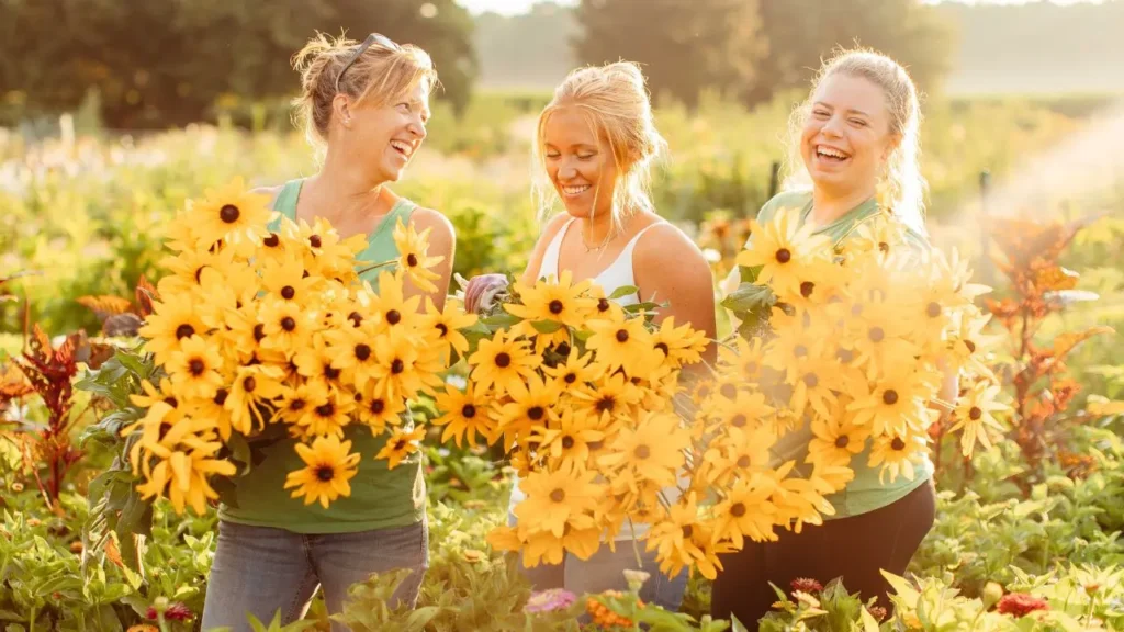 the-flower-files-episode-126-featured-image Liza, Lizzy and Amber holding up flowers in the field at Wildly Native Flower Farm