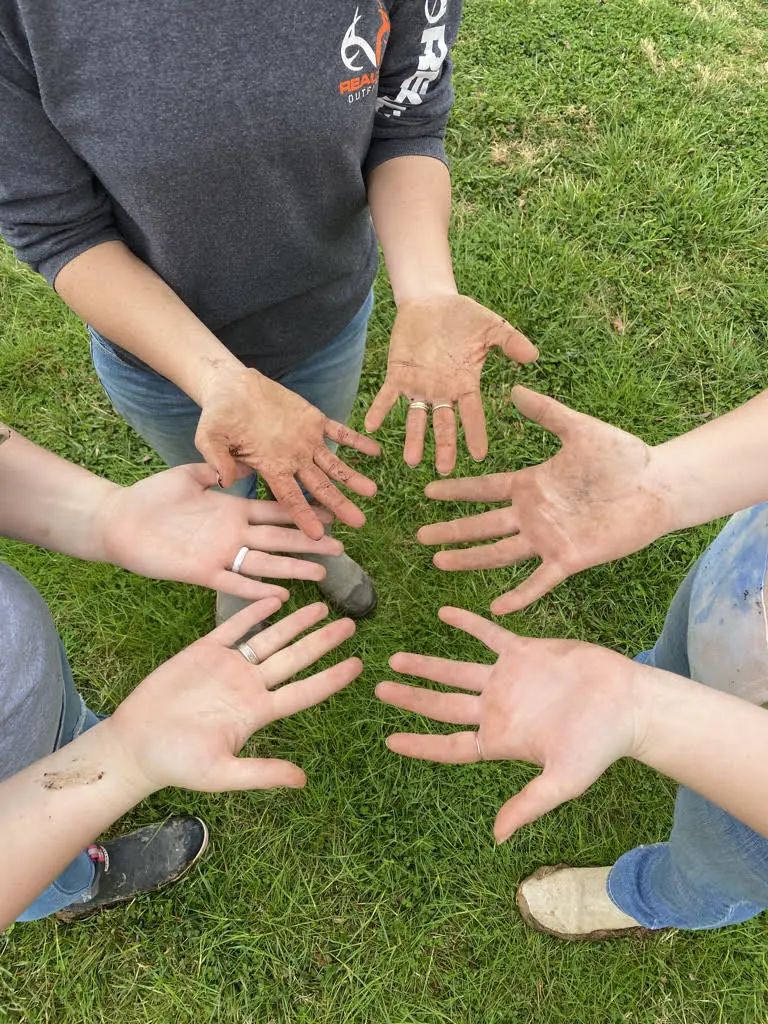 dirty-hands The wildly native flower farm team hands in a circle, dirty