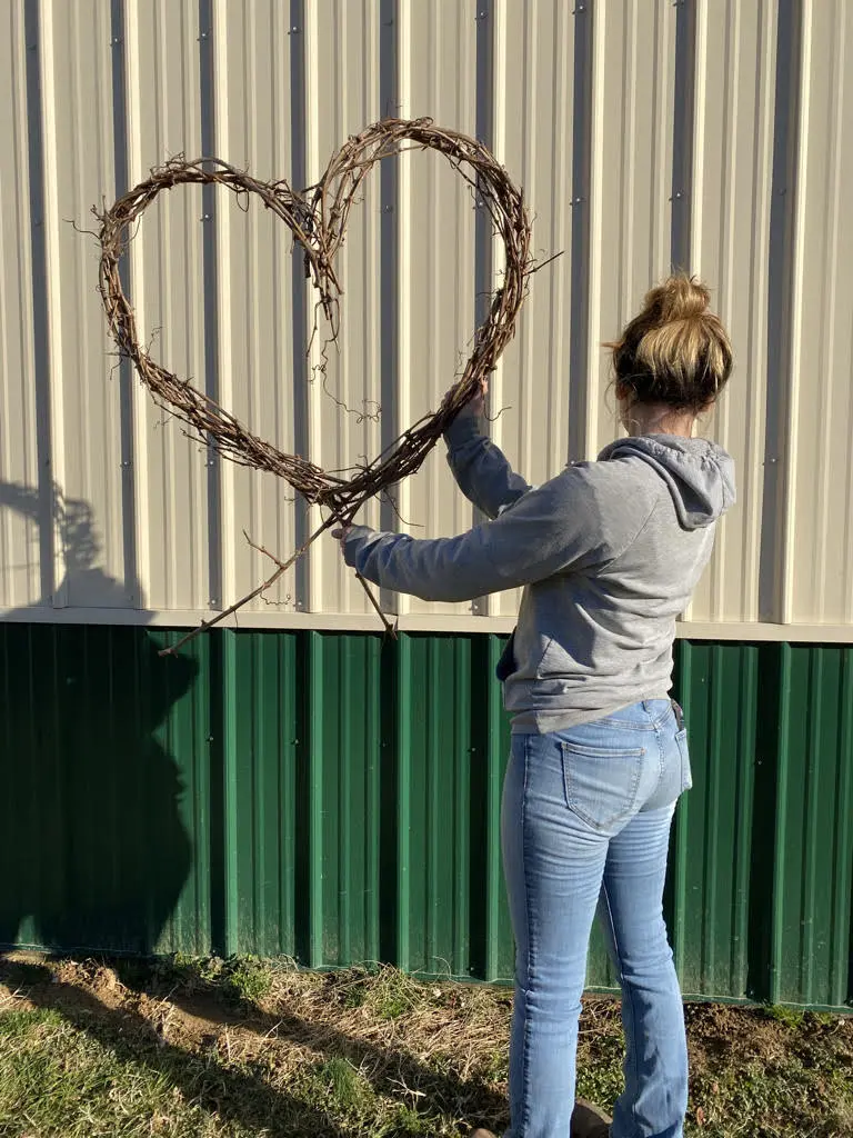 starting-making-grapvine-wreaths Holding a grapevine wreath in the shape of a heart